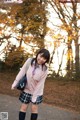 A young woman in a school uniform posing for a picture.